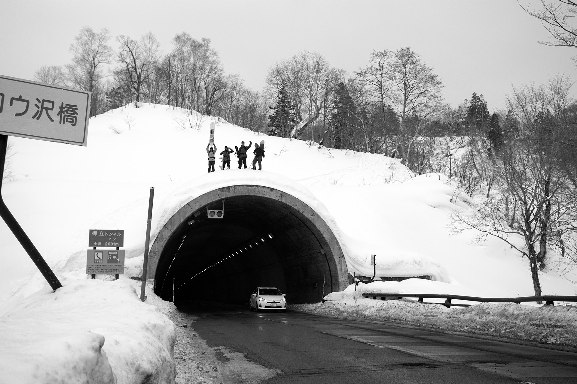 The crew waving from the top of a tunnel portal