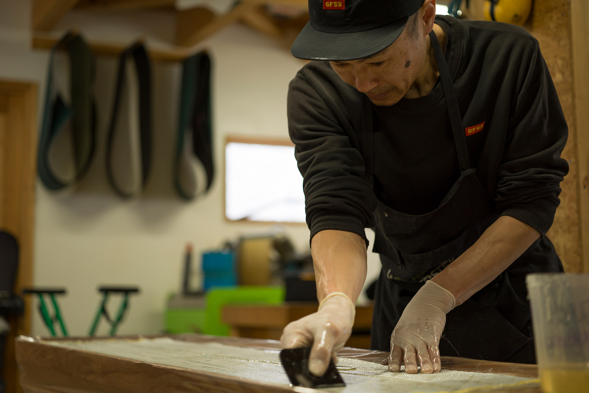 Spreading resin through the fiberglass with a squeegee