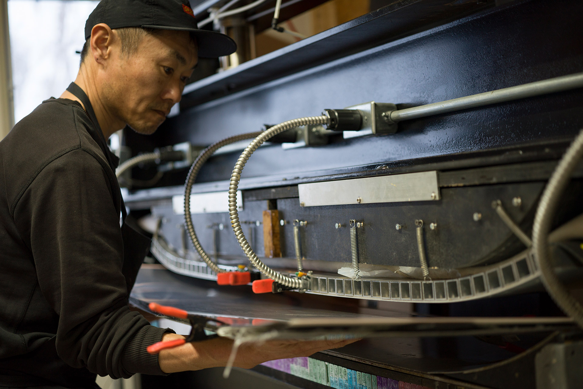 Feeding the layup into the pneumatic press, springs and camber blocks above