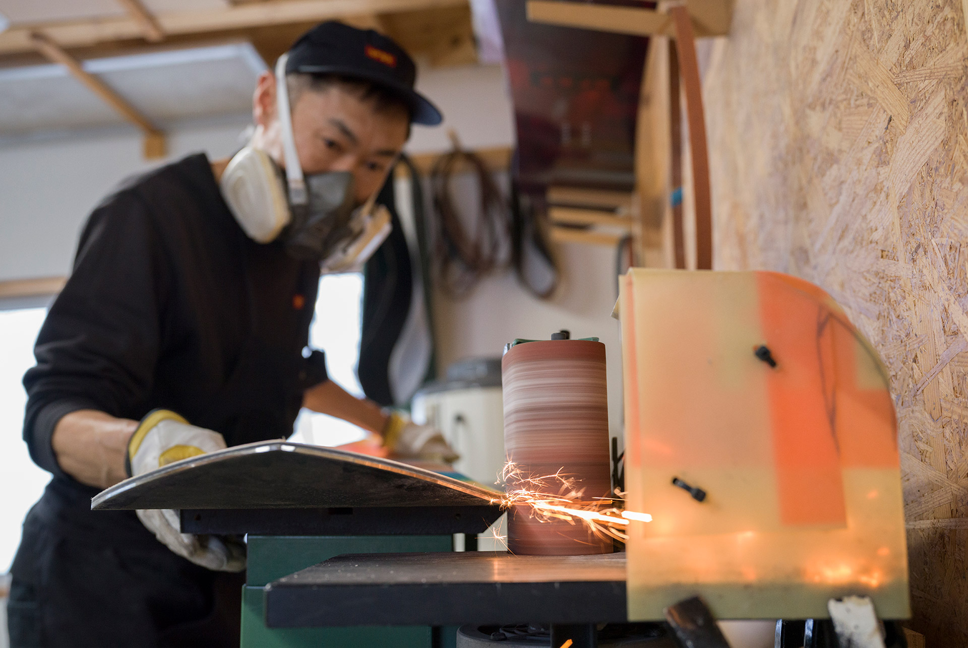 Grinding a board edge, sparks off the belt