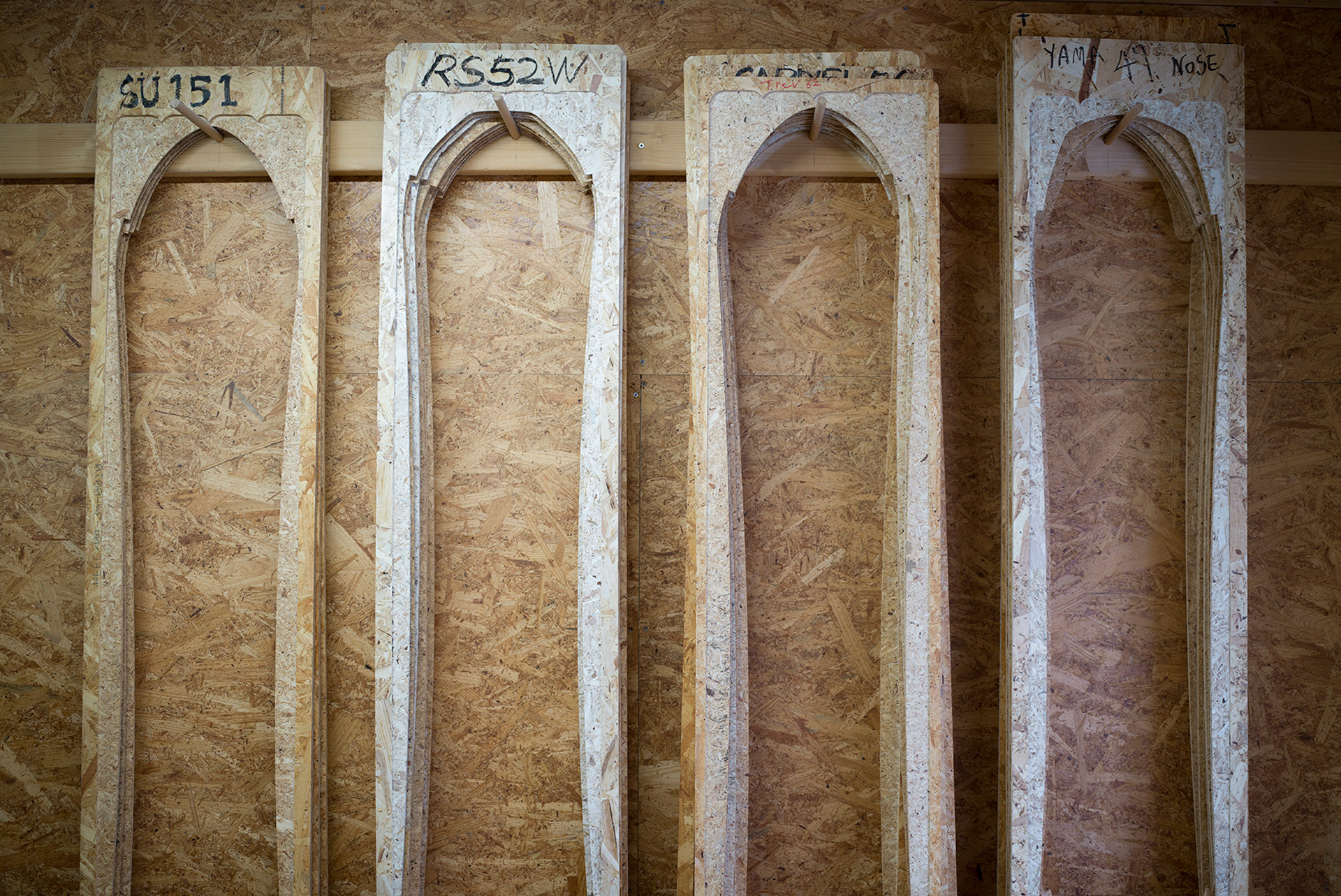 Core templates on the workshop wall, one for each shape