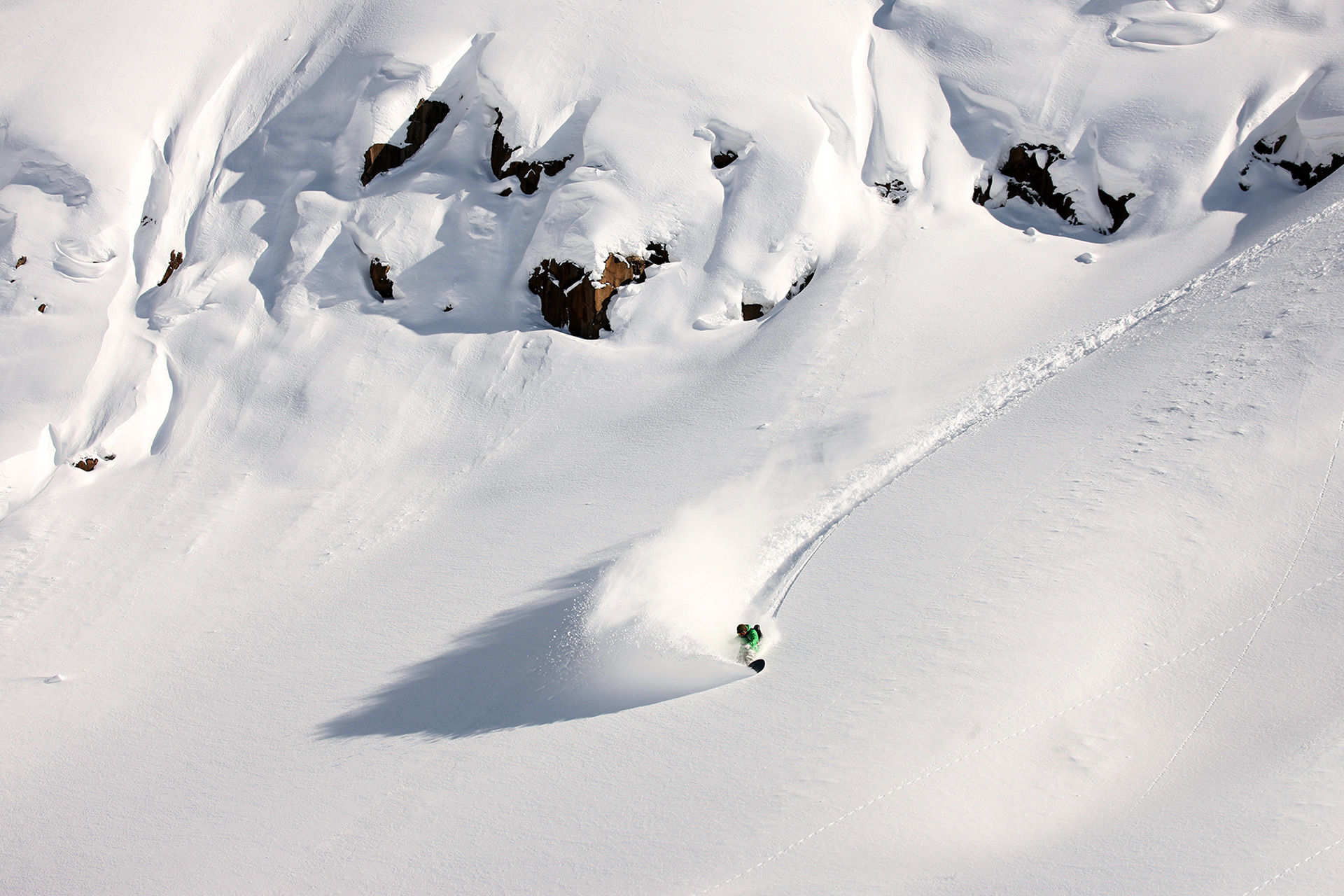 Josh Mon riding the Snurfs Up 157 in Niseko